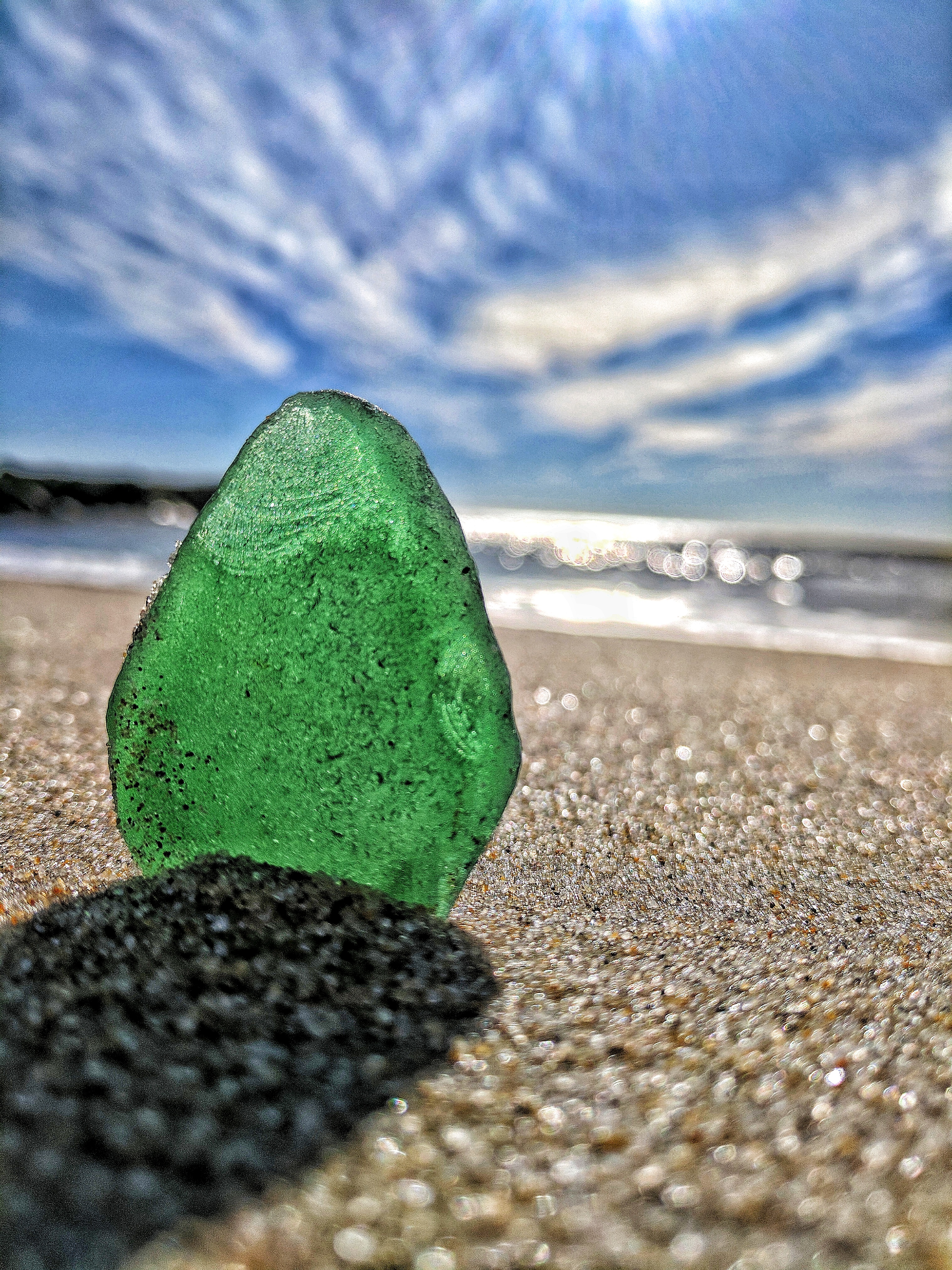 Green sea glass on the beach